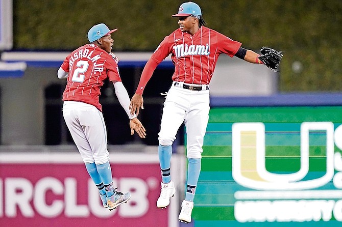 Miami Marlins second baseman Jasrado “Jazz” Chisholm Jr (2) and left fielder Lewis Brinson, right, celebrate after a baseball game against the Philadelphia Phillies on Saturday in Miami.