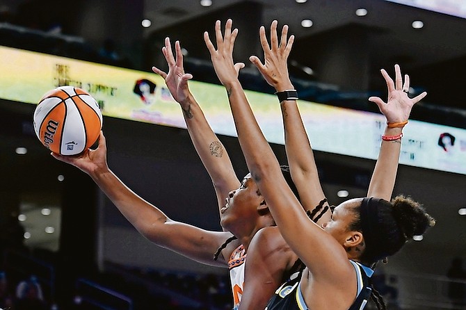 Connecticut Sun’s Jonquel Jones (35) goes up for a shot against Chicago Sky’s Azura Stevens (30) and Candace Parker (3) during the first half of Game 3 of their WNBA semifinal playoff game yesterday in Chicago. Chicago won 86-83.

(AP Photo/Paul Beaty)