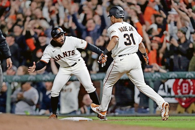 San Francisco Giants’ LaMonte Wade Jr is congratulated by first base coach Antoan Richardson after hitting a game winning single against the Arizona Diamondbacks during the ninth inning in San Francisco on September 30. 
(AP Photo/Jed Jacobsohn)