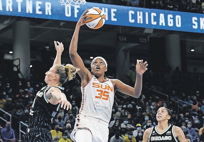 JONQUEL Jones goes up for a shot against Sky’s Courtney Vandersloot (22) and Candice Parker right, during the second half of Game 4 of their WNBA playoff semifinal yesterday in Chicago. Chicago won 79-69. 
(AP Photo/ Paul Beaty)