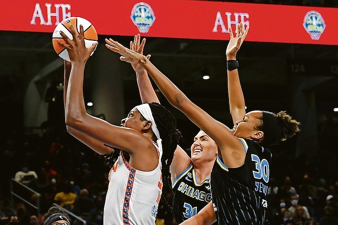 Connecticut Sun’s Jonquel Jones (35) goes up for a shot against Chicago Sky’s Azura Stevens (30) and Stefanie Dolson (31) during the second half of Game 4 of their WNBA basketball playoff semifinal on Wednesday night in Chicago. Chicago won 79-69.

(AP Photo/Paul Beaty)