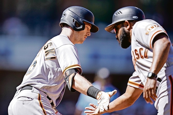 San Francisco Giants’ Mike Yastrzemski, left, is greeted by first base coach Antoan Richardson after hitting a two-run home run in the second inning against the San Diego Padres on Thursday, September 23 in San Diego.

(AP Photo/Gregory Bull)