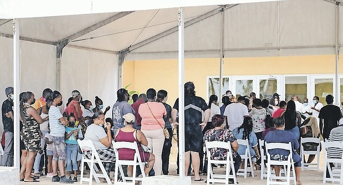 LONG lines at Kendal Issac Gymnasium yesterday as locals wait to get vaccinated. Photo: Donovan McIntosh/Tribune Staff