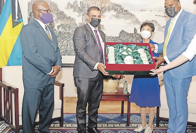 CLAY Sweeting hands over a token of appreciation to Chinese Ambassador Dai Qingli at the handover ceremony for 15 greenhouses donated by China to The Bahamas.
Photos: Donovan McIntosh/Tribune Staff