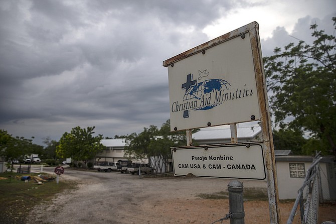 A custom sign stands outside Christian Aid Ministries in Titanyen, north of Port-au-Prince, Haiti, Tuesday. A gang kidnapped 17 members of the U.S.-based missionary group on Oct. 16. (AP Photo/Joseph Odelyn)