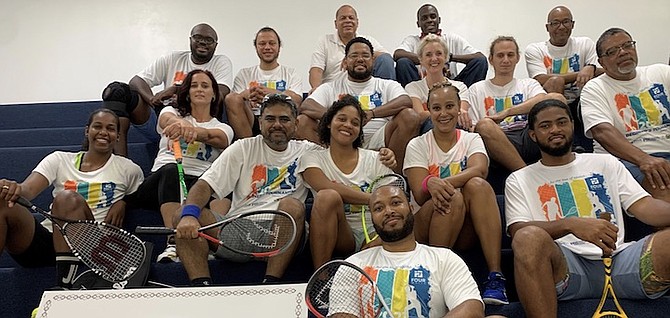 COMPETITORS sit alongside their squash coaches and referees for a group photo on the championship stadium court after an intense round of qualifying matches.