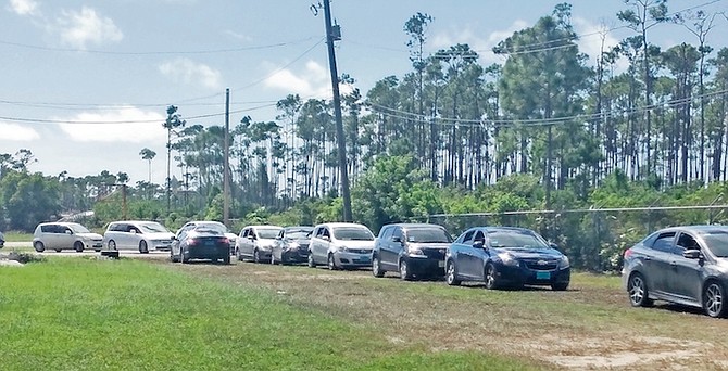 CARS lined up for the distribution of coupons in Grand Bahama.
Photo: Denise Maycock/Tribune Staff