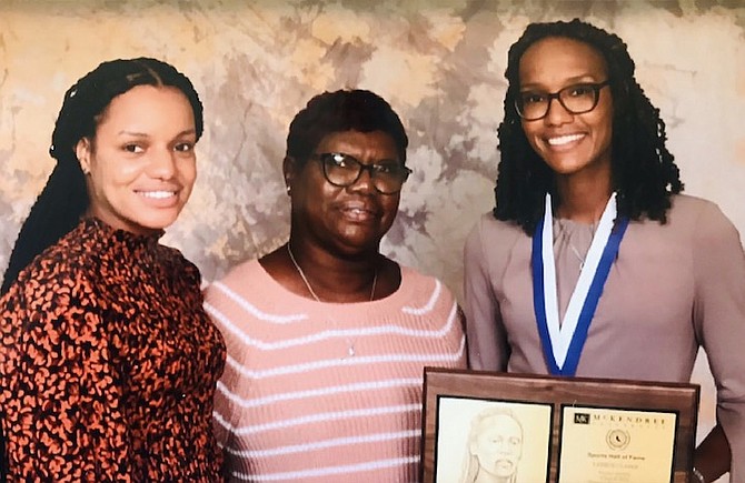 LANECE CLARKE, far right, her sister Shant’e and mother Maryann Higgs-Clarke with her Hall of Fame awards from McKendree University.