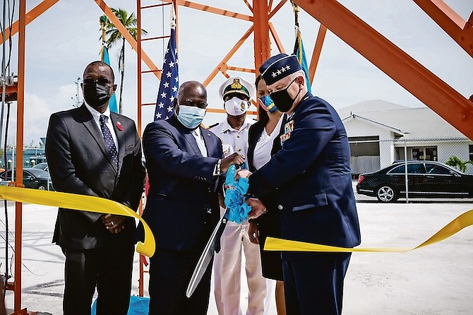 General Glen VanHerck (right), and Prime Minister Philip Davis (centre left) cut the ribbon on the new radar system, along with US Chargé Usha Pitts (second from right), Minister of National Security Wayne Munroe (left), and Commodore Raymond King (centre).