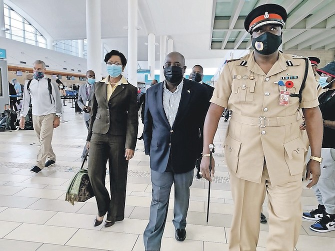 PRIME Minister Philip “Brave” Davis and his wife Ann Marie escorted by Police Commissioner Paul Rolle as they departing for the UN Climate Change Conference in Scotland. Photo: Kristaan Ingraham/BIS
