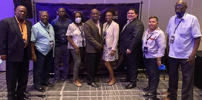 BURKETT DORSETT, second from left, is joined by the English Caribbean Amateur Softball Confederation delegation at the World Baseball Softball Confederation.