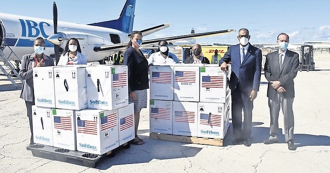A SHIPMENT of 134,550 Pfizer vaccine doses arrives at Lynden Pindling International Airport yesterday. Present to meet the shipment were Minister of Health and Wellness Dr Michael Darville; US Embassy Charge d’Affaires Usha Pitts; Permanent Secretary of the Ministry of Health and Wellness Colin Higgs; Chief Medical Officer Dr Pearl McMillan, and other officials. Photo: Patrick Hanna/BIS
