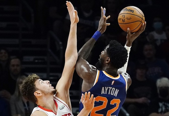 HOUSTON Rockets centre Alperen Sengun, left, defends against a shot by Phoenix Suns centre Deandre Ayton (22) during the first half last night in Phoenix. 
(AP Photo/Ross D Franklin)