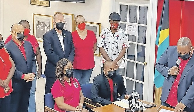 A photo from Kwasi Thompson’s Facebook page showing him handing in his nomination form at the FNM headquarters.