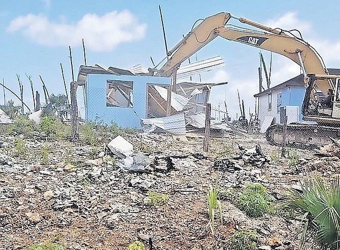 DEMOLITION work taking place earlier this year in The Farm shanty town in Abaco.