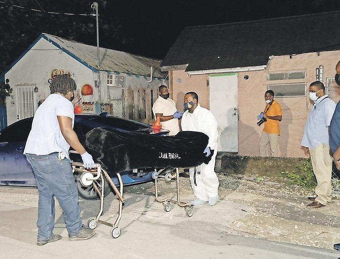 A BODY is pictured being taken from the scene of last night’s shooting. 
Photo: Racardo Thomas/ Tribune Staff