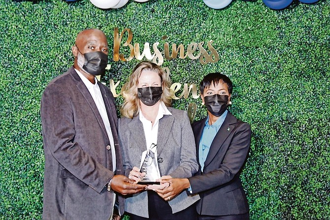 CHAMBER President Greg Laroda (left) presenting Leslie Baptista, vice president of Paint Fair, with President’s Award, along with Minister Ginger Moxey, right.