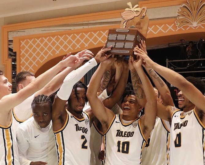 CHAMPIONS: Toledo Rockets players celebrate with their championship trophy last night after defeating the Coastal Carolina Chanticleers 79-70 to win the Nassau Championship at the Baha Mar Convention Center.