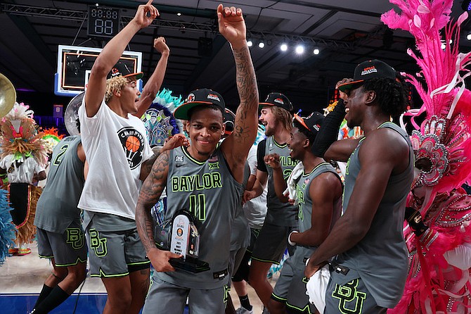Baylor guard James Akinjo (11), the tournament's MVP, celebrates with teammates after defeating Michigan State in an NCAA college basketball game at Paradise Island, Bahamas, Friday, Nov. 26, 2021. (Tim Aylen/Bahamas Visual Services via AP)
