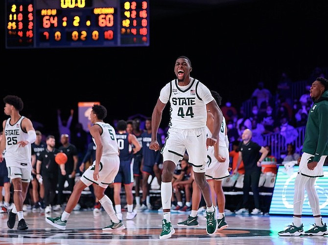MICHIGAN State forward Gabe Brown (44) and teammates celebrate after defeating Connecticut 64-60 yesterday in their NCAA college basketball game at the Atlantis resort’s Imperial Arena on Paradise Island in the Bahamas. 
(Tim Aylen/Bahamas Visual Services via AP)