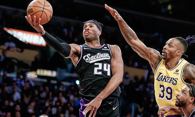 KINGS guard Chavano “Buddy” Hield (24) goes to the basket while defended by Lakers centre Dwight Howard (39) during the 2nd half in Los Angeles on November 26. In a 128-101 loss to the Grizzlies last night, Hield led the Kings with 14 points, but was 5 of 17 from the field. (AP Photo/Ringo H.W. Chiu)