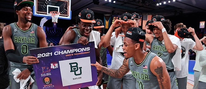 BAYLOR guard James Akinjo (11) celebrates with teammates after defeating Michigan State, claiming their second Battle 4 Atlantis title in programme history. The No.6 Bears defeated the Spartans 75-58 in Friday’s championship game at the Atlantis resort’s Imperial Arena on Paradise Island. 
(Tim Aylen/Bahamas Visual Services via AP)