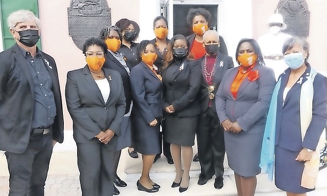 ZONTA members outside the House of Assembly yesterday, along with a Rotary Club member marking “16 Days of Activism to End Violence Against Women and Girls”.