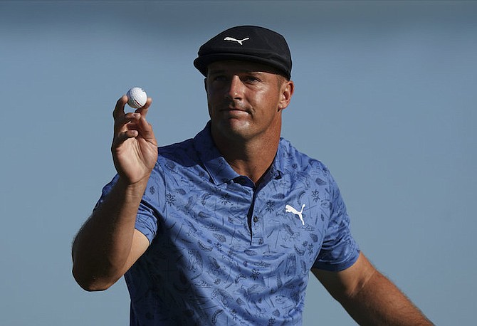 Bryson DeChambeau, of the United States, reacts to his putt on the 18th hole during the second round of the Hero World Challenge PGA Tour at the Albany Golf Club on Friday. (AP Photo/Fernando Llano)