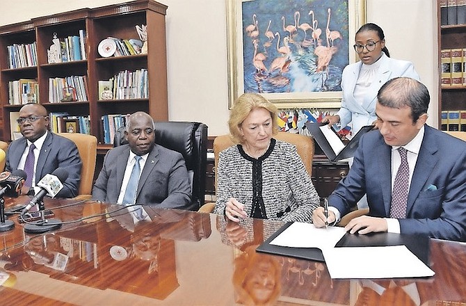 DANIEL ZULETA MARTINEZ, Local Manager, Cotton Bay Holdings Ltd., Eleuthera, signs Heads of Agreement between the Bahamas Government and Cotton Bay Holdings Ltd for the addition of The Ritz-Carlton to that South Eleuthera property. The agreement was signed during a ceremony at the Office of the Prime Minister on Monday, December 6, 2021. Looking on are the Hon. Chester Cooper, Deputy Prime Minister and Minister of Tourism, Investments and Aviation; the Hon. Philip Davis, Prime Minister and Minister of Finance; Lynn Holowesko, attorney; and standing, Phylicia Woods-Hanna, Director of Investments, Bahamas Investment Authority.
Photo:Kemuel Stubbs/BIS