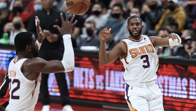 PHOENIX Suns guard Chris Paul, right, passes the ball to Suns centre Deandre Ayton, left, during the second half against the Portland Trail Blazers in Portland, Oregon, on Tuesday night. Phoenix defeated Portland 111-107 in overtime.
(AP Photo/Steve Dipaola)
