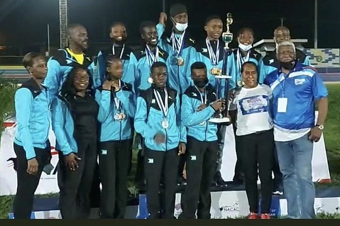 AGE GROUP CHAMPIONS: Team Bahamas members proudly display their championship trophy with NACAC president Mike Sands, far right, after being crowned the overall champions of the North American, Central American and Caribbean Age Group Championships over the weekend in Managua, the capital of Nicaragua.