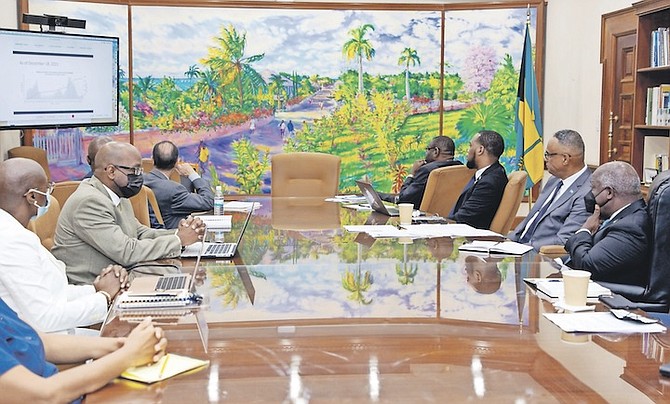 IN this image posted to social media, Prime MInister Philip “Brave” Davis is pictured receiving a briefing from the COVID-19 Task Force.