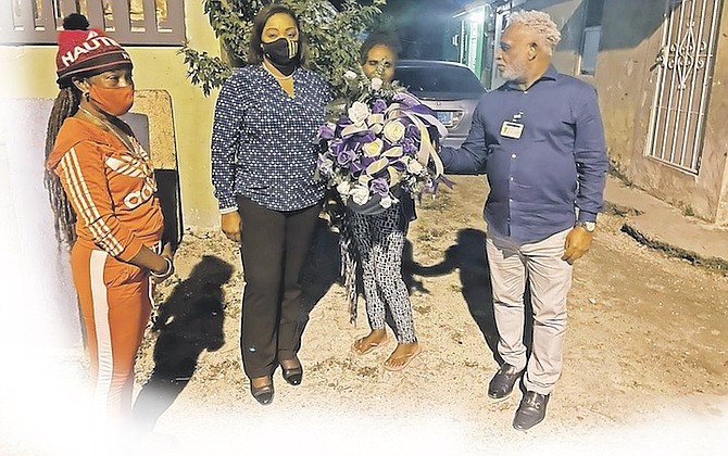 STATE Minister in the Ministry of Social Services and Urban Development Lisa Rahming presenting a wreath to the family of Heavenly Terveus after the photographer was shot and killed in her home in front of her one-month-old son.