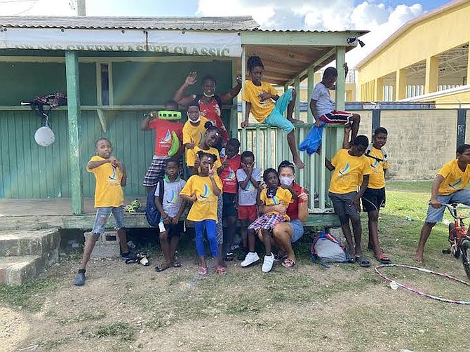 ROBIN PREST, of the I CAN Foundation, with children in Antigua being helped by the programme.