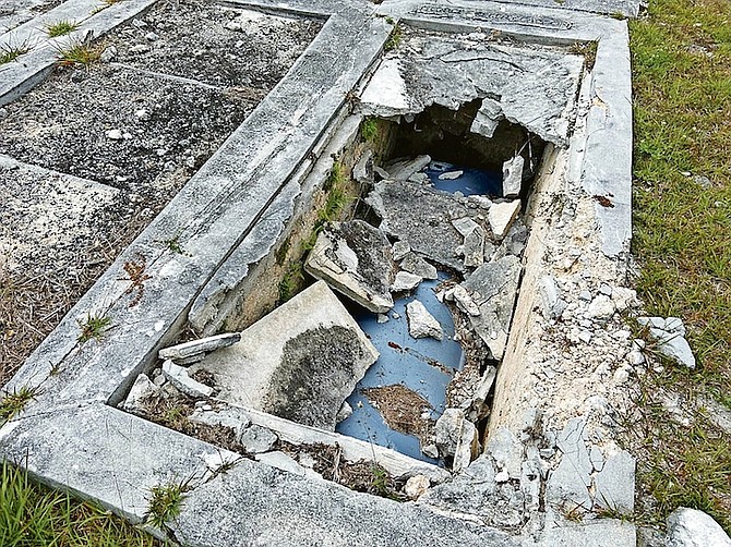 A coffin exposed after damage to a grave in the Spikenard Cemetery. 
Photo: Racardo Thomas/Tribune Staff