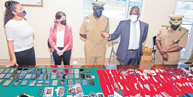 CONFISCATED contrabands at the Bahamas Department of Corrections with, left, Usha Pitts, Chargé D’Affaires at the US Embassy, and Wayne Munroe, Minister of National Security.
Photo: Donavan McIntosh/Tribune Staff