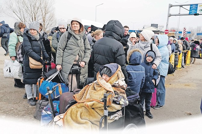 Refugees fleeing the war from Ukraine arrive at the border crossing in Palanca, Moldova, yesterday.
Photo: Sergei Grits/AP