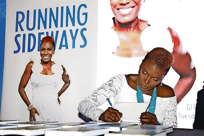 PAULINE Davis signing copies of her book. Photos: Racardo Thomas/Tribune Staff