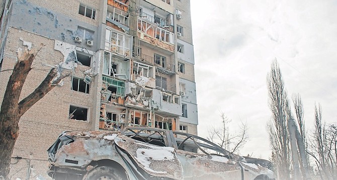 A DESTROYED car in front of a building damaged by shelling, in Kharkiv, Ukraine, yesterday. 
Photo: Andrew Marienko/AP