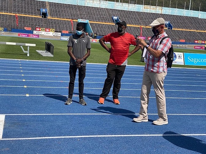 OFFICIALS inspect the equipment for the CARIFTA Games in Jamaica.