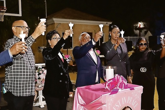 CANDLES are raised in memory of young mother Carissa Culmer last night during a vigil at Southern Recreational Grounds attended by Ann Marie Davis.
Photos: Racardo Thomas/Tribune Staff