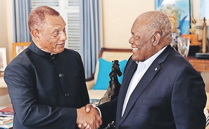 FORMER Prime Ministers Perry Christie and Hubert Ingraham shaking hands yesterday as Mr Ingraham presented a signed copy of his book of speeches to Mr Christie.
Photo: Donavan McIntosh/Tribune Staff