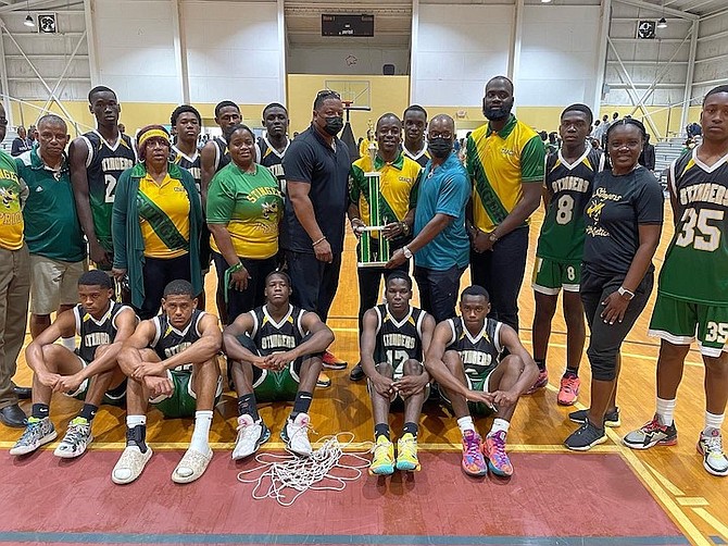Sunland Baptist Stingers presented with their championship trophy by GBSSAA president Derek Wells and Central Grand Bahama MP and former Minister of Sports Iram Lewis.