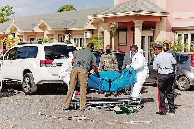 A BODY is removed from the scene at Stew Fish Drive off Carmichael Road yesterday. Photos: Donavan McIntosh/Tribune Staff