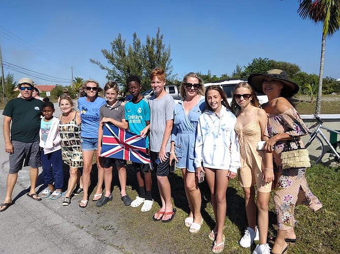 Mary Silvera and a group of family and friends gather on Midshipman Road, the route taken by Prince William and Kate to Coral Vita on Saturday.