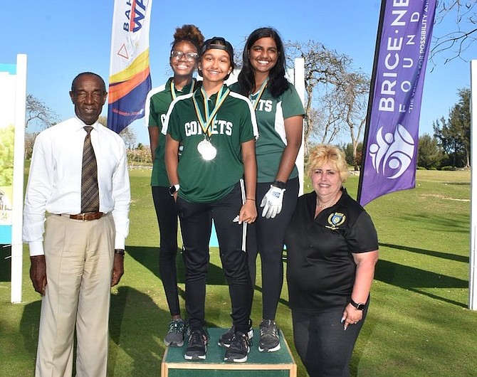 QUEEN’S College senior girls winning team on the medal podium. Craig Flowers, far left, and Gina Gonzalez-Rolle, look on.