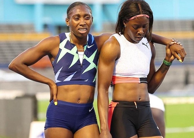 BAHAMIAN sprinter Anthonique Strachan, left, is assisted by her Jamaican training partner Shericka
Jackson after running a 400 metre race in Kingston, Jamaica.