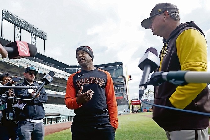 SAN Francisco Giants first base coach Antoan Richardson, centre, speaks at a news conference next to San Diego Padres third base coach Mike Shildt on Wednesday. (AP Photo/Jeff Chiu)