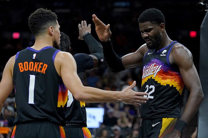 SUNS centre Deandre Ayton (22) celebrates a blocked shot with guard Devin Booker (1) and forward Jae Crowder during the second half of Game 1 on Sunday in Phoenix.
(AP Photo/Matt York)