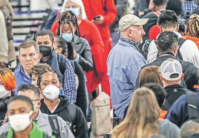 CROWDS of the masked and the unmasked went through the security line at Hartsfield-Jackson International Airport yesterday where the airport issued a statement saying masks are now “optional for employees, passengers, and visitors” at the airport. 
Photo: John Spink/Atlanta Journal- Constitution via AP